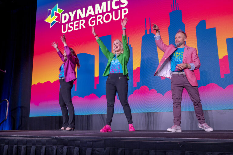 Presenters celebrating onstage at a corporate conference