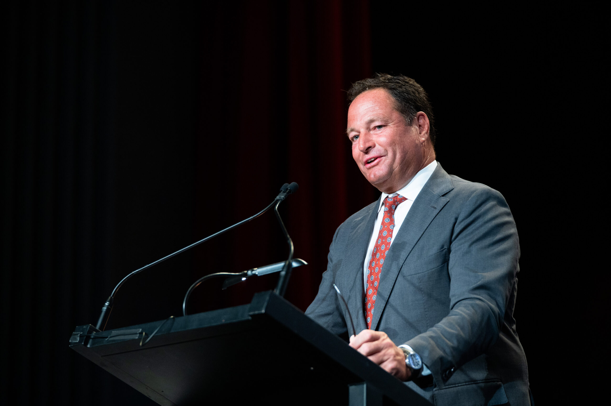 Executive speaker delivering remarks from a lectern