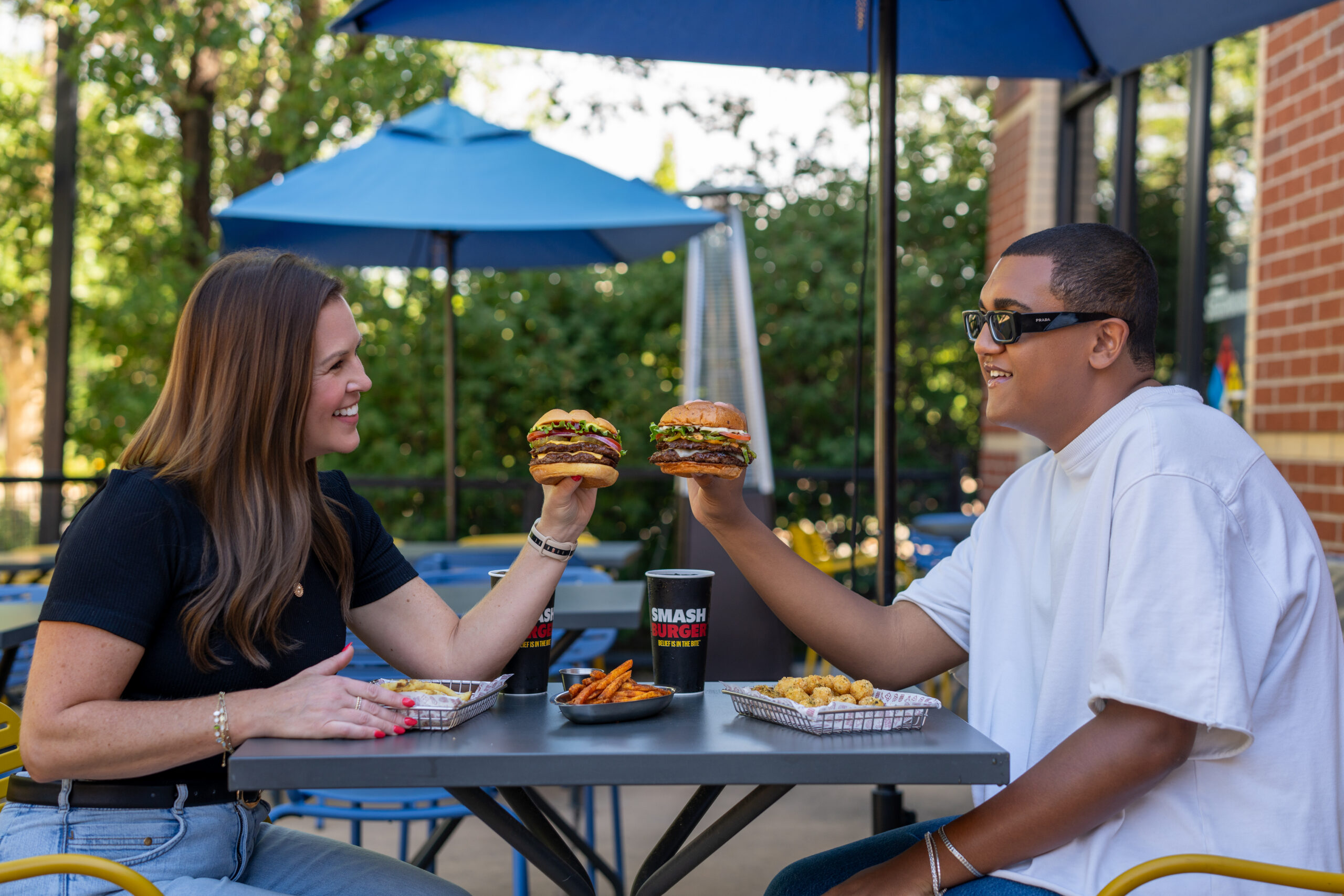 Lifestyle product photography for Smashburger featuring guests and burgers