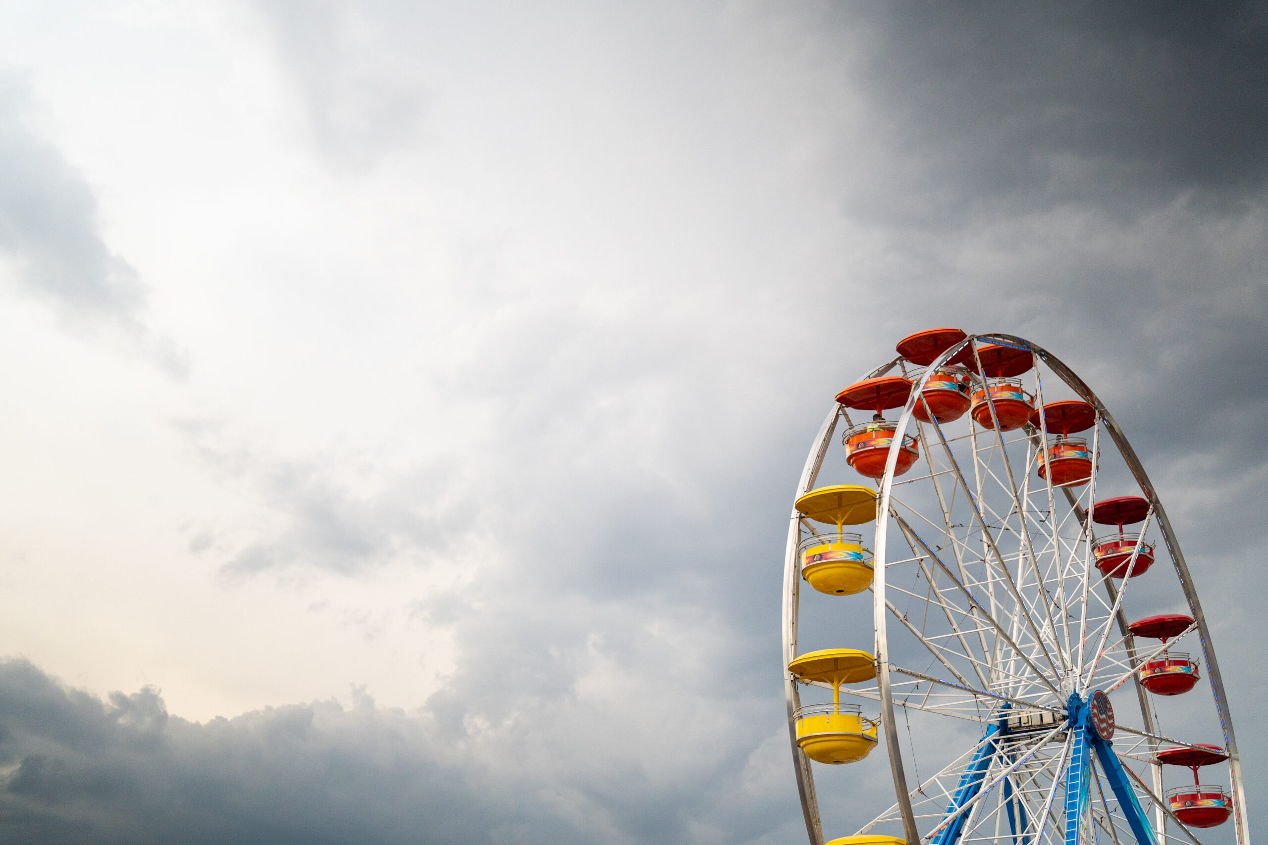 Ferris wheel beneath dramatic storm clouds at the Arapahoe County Fairgrounds