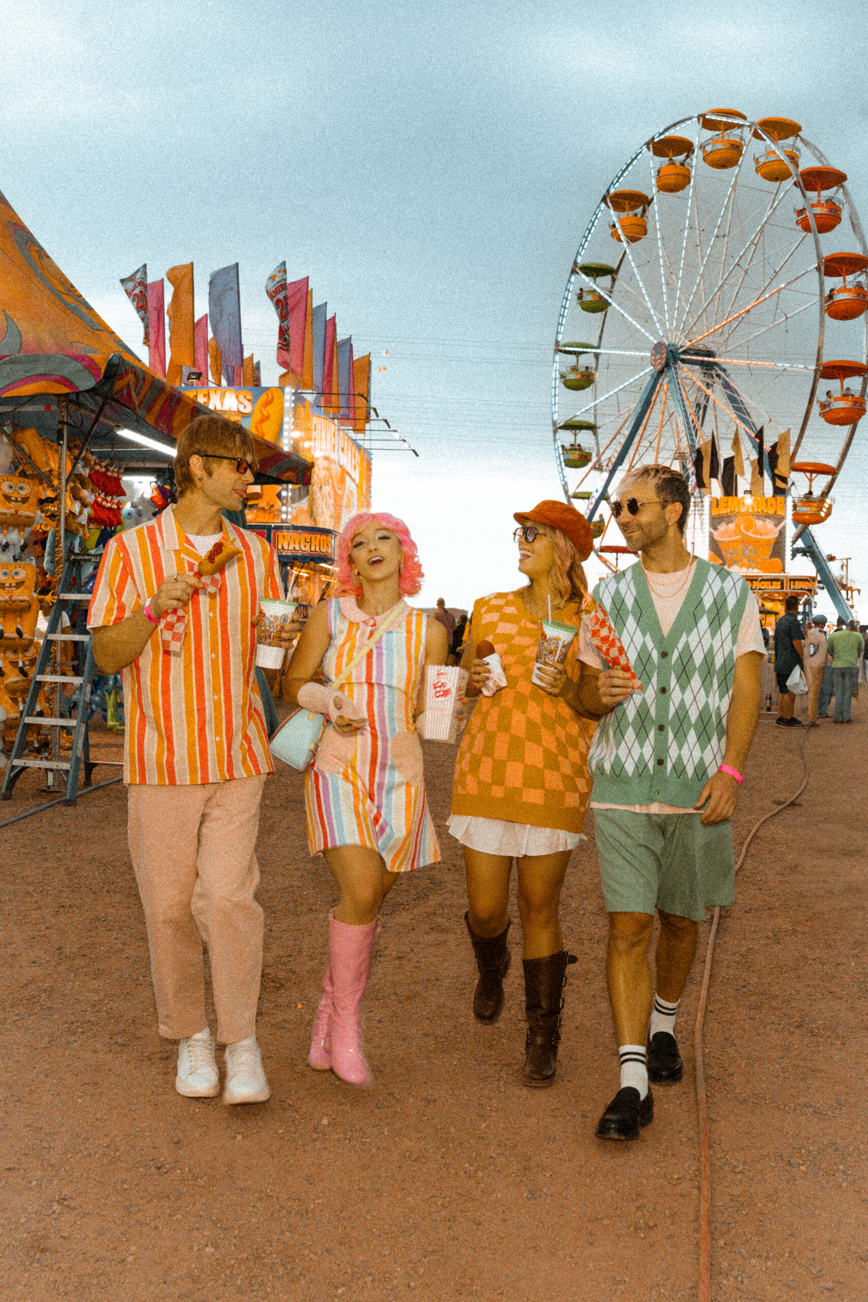 Four retro-styled models walking through the midway at the Arapahoe County Fair