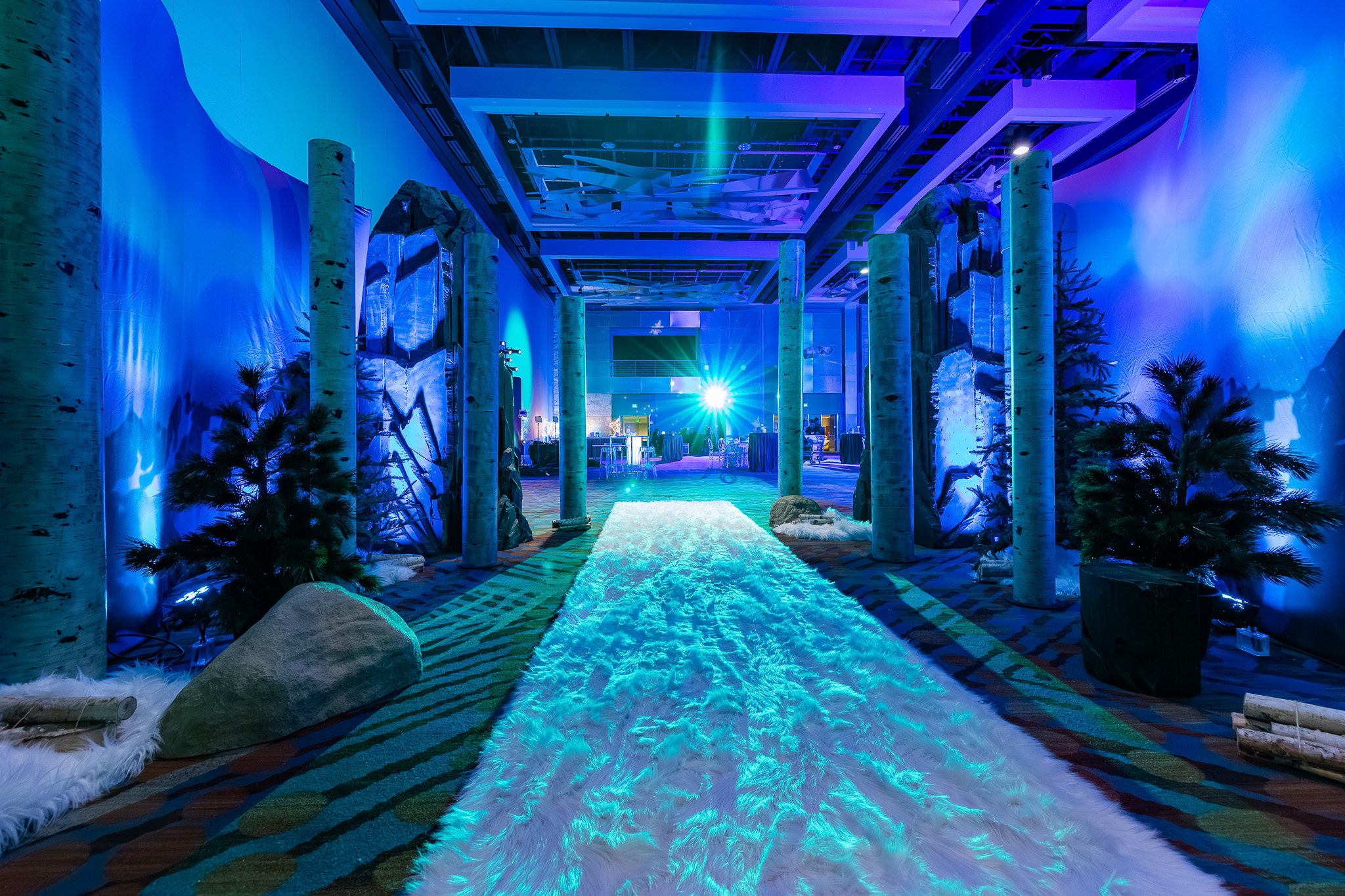 Immersive blue event entrance with custom lighting and scenic design