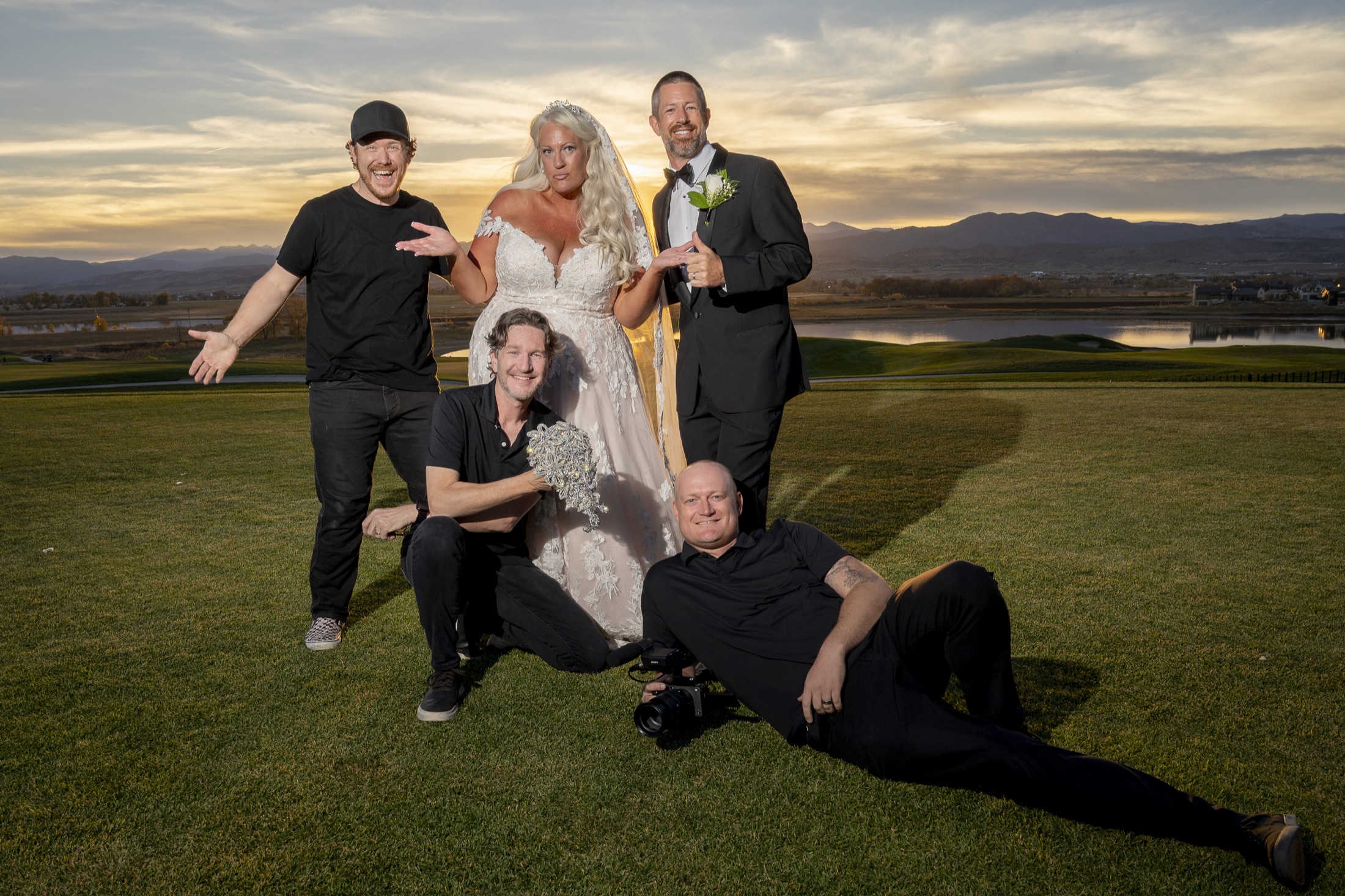 Emberlight Media team members celebrating with wedding clients at sunset